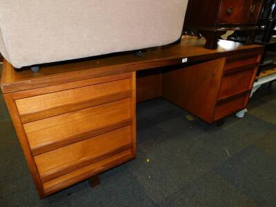 A teak kneehole office desk, with a gold leatherette top and six drawers, 73cm high, 183cm wide, 107cm deep.