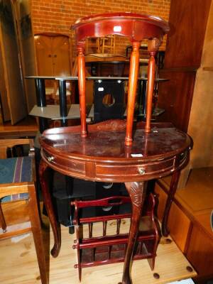 A mahogany demi-lune hall table, 73cm wide, further demi-lune table, magazine rack and two glass television stands. (5)