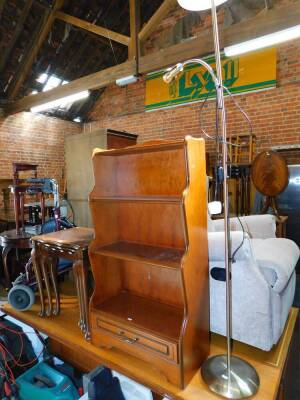 A nest of mahogany occasional tables, largest 55cm wide, 42cm deep, together with a waterfall bookcase, 59cm wide, 28cm deep and metal standard lamp with angle poise lamp attachment. (3)