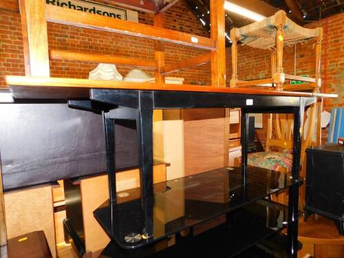 A teak and ebonised wooden rectangular occasional table, 152cm wide.