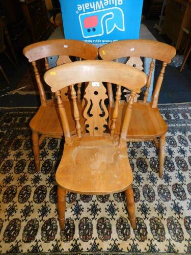 A set of three beech kitchen chairs.