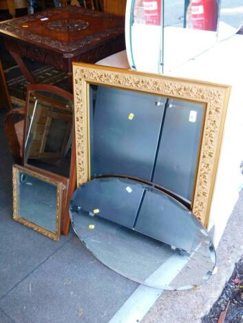 A rectangular embossed gilt wood and cream painted rectangular wall mirror, inset bevel glass, 66cm high, 91cm wide and oval bevel glass wall mirror, 73cm wide and a teak oblong wall mirror, 78cm wide. (3)