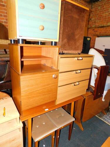 A teak and beech kitchen table, 91.5cm wide, a pair of upholstered oak stools, a pine MDF three drawer chest, two further MDF chests and a linen basket. (7)