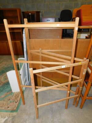 A pine bi-fold clothes airer, 88cm high, and a three fold clothes airer, 137cm high.