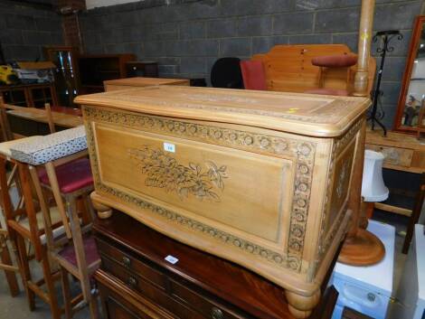 A Chinese floral carved soft wood serpentine chest, 92cm wide, 42cm deep, 45cm high.