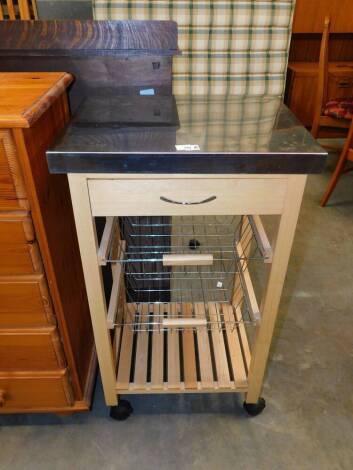 A kitchen mobile trolley, with sheet metal top drawer and baskets.