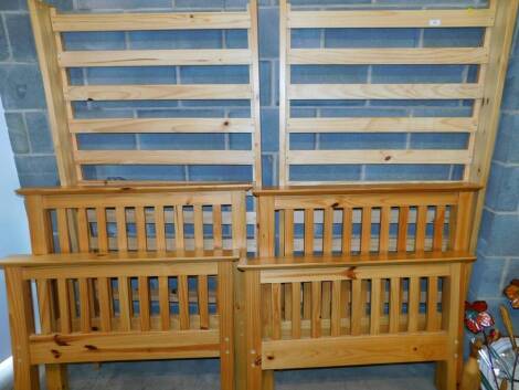 A pair of pine single bedsteads.