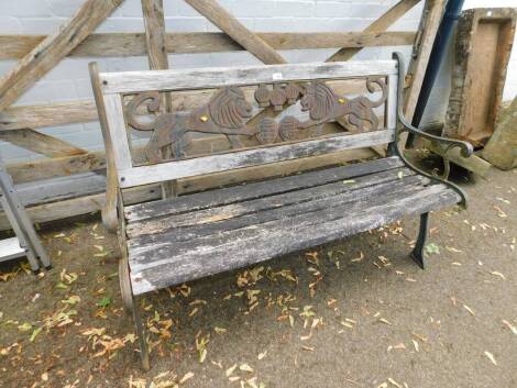 A modern cast iron bench, 128cm wide, with lion cast back and wooden slats.