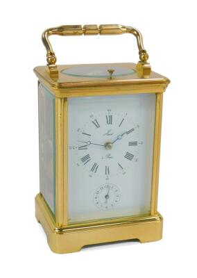 A Jacot A Paris brass cased repeater alarm carriage clock, rectangular dial bearing Roman and Arabic numerals, subsidiary alarm dial with coil strike, with key, 14cm high, 9cm wide, 8cm deep.