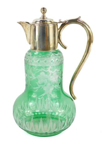 A late Victorian green glass claret jug, probably Stevens and Williams, engraved with blossom, with silver mount, handle and hinged lid, Birmingham 1900, 24.5cm high.