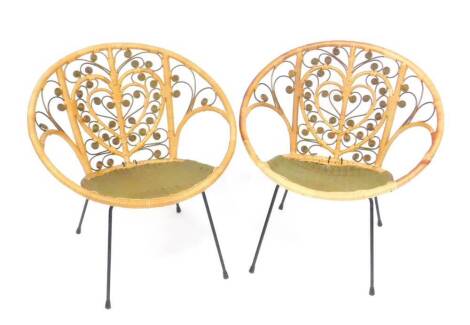 A pair of vintage mid 20thC cane effect flex wire and cast iron tub conservatory chairs, with double heart shaped backs.