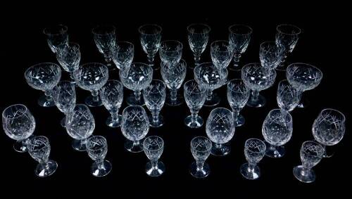 A Webb Corbett cut glass part suite of table glassware, decorated in the Georgian pattern, comprising six champagne cups, red and white wine glasses, sherry glasses, brandy balloons and liqueur glasses. (36)