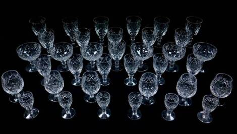 A Webb Corbett cut glass part suite of table glassware, decorated in the Georgian pattern, comprising six champagne cups, red and white wine glasses, sherry glasses, brandy balloons and liqueur glasses. (36)