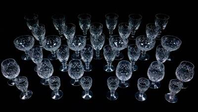 A Webb Corbett cut glass part suite of table glassware, decorated in the Georgian pattern, comprising six champagne cups, red and white wine glasses, sherry glasses, brandy balloons and liqueur glasses. (36)