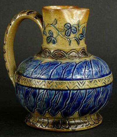 A late 19thC stoneware jug by T. Smith, in the manner of Royal Doulton, with incised decoration in blue and brown, oval stamp to underside for T. Smith and Co Old Kent Road, 15cm high. Provenance: The Dayabandhu Collection