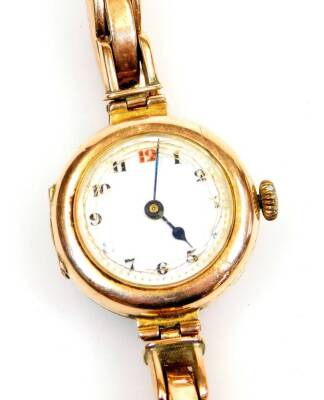 A 9ct gold cased wristwatch, the 2cm diameter Arabic dial in plain case with elasticated bracelet marked 9ct, 21g all in.