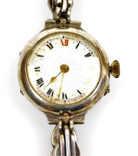 An early 20thC wristwatch, with fancy 2cm diameter enamel dial with Roman numerals, in a white metal case marked 925, with elaborate strap.