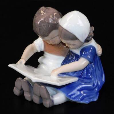 A 20thC B & G Copenhagen figure group of children, no.1567, predominately in blue and white, marks beneath, 9cm high.