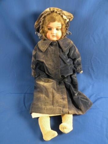 An Armand Marseille bisque headed doll with brown wig