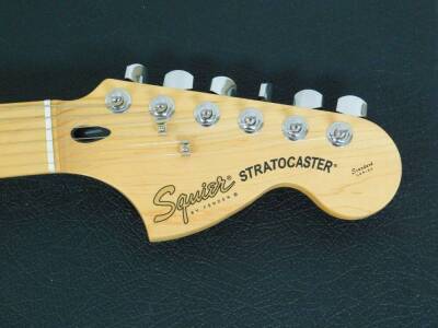 A late Squier Stratocaster Fender standard series guitar, marked Crafted In China, S/N/CY02117023, with shaped body in fitted case, 107cm wide and other items. (a quantity) - 4