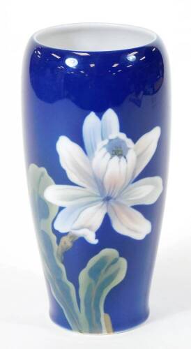 A late 20thC Royal Copenhagen vase, of circular form decorated with flowers on a blue ground, no. 2797235, printed marks beneath, initialled TV, 17cm high.