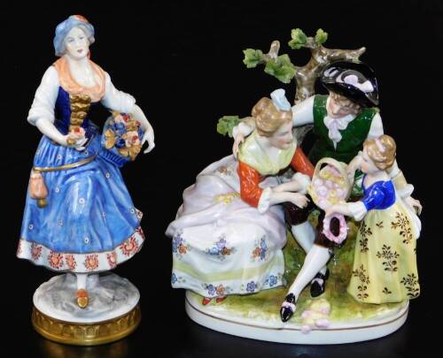 A 20thC Volkstedt RSS porcelain figure of a lady, polychrome decorated and dressed in finery holding basket of flowers with gilt highlights, marked beneath, and a further porcelain group of figures and basket before tree bough. (2)