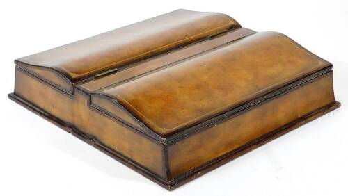 A 20thC desk box, in brown tooled leatherette, with two serpentine openings, on a plain base, 8cm high, 35cm wide, 33cm deep.