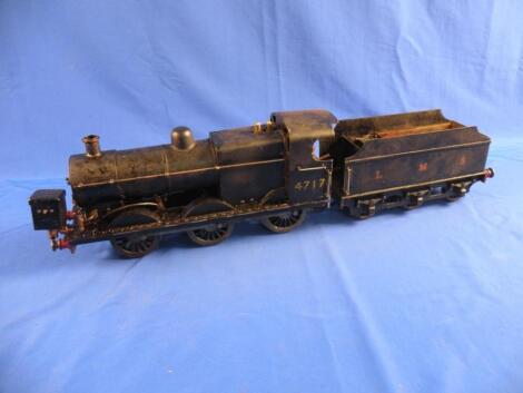 Gauge One. A locomotive painted in black and gilt and tender