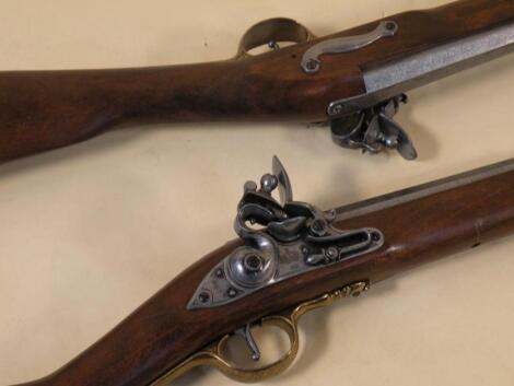 A pair of stained beech replica muskets and bayonets in 19thC