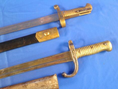 A French bayonet with a steel scabbard and hilt and a brass handle