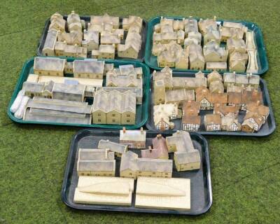 Various railway related buildings, pottery finish plaster train accessories, cottages, 12cm wide, part stations, engine sheds, mock Tudor and other buildings, plaster churches, further sheds, rail related, etc. (a quantity)
