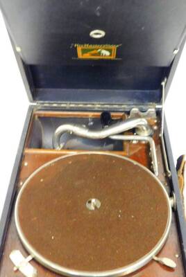 A mid 20thC HMV table record player, of rectangular form in pressed leather case, with brown baize, 24cm dia turntable and articulated chrome arm with handle, the case 11cm high, 29cm wide, 43cm deep. - 2