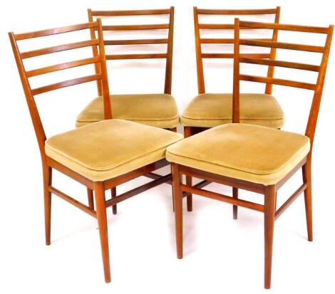 A set of Vintage Meredew teak ladder back dining chairs, each with four horizontal splats, on turned legs with overstuffed seats, 85cm high. (4) The upholstery in this lot does not comply with the 1988 (Fire & Fire Furnishing) Regulations, unless sold to