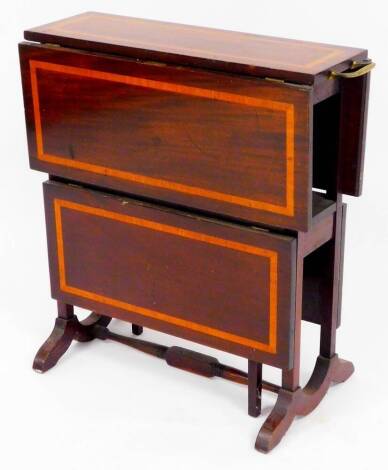 An Edwardian mahogany double Sutherland table, with a boxwood stringing and fixed brass handles on square legs joined by a turned stretcher, with double leaf sections, when closed 63cm high, 63cm wide, 23cm deep.