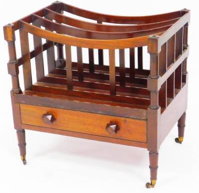 A Regency style mahogany Canterbury, of rectangular form with four sections flanked by horizontal supports on turned legs with front drawer, set with carved handles, 50cm high, 59cm wide, 37cm deep. (AF)