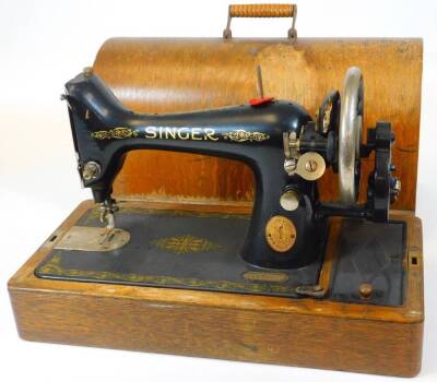 An early 20thC Singer sewing machine, No. YL479780, 44cm wide, in dome case.