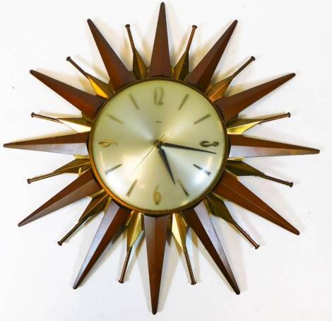 A vintage Metamec Sunburst wall clock, the 17cm diameter dial with baton and Arabic numerals with a teak and metal star burst surround, Metamec enclosed movement, 46cm high, 46cm wide.