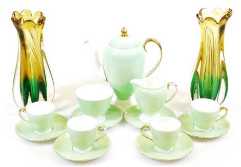 A Wedgwood bone china part coffee service, comprising coffee pot 25cm high, milk jug, sugar bowl, four cups and six saucers, each in green with gilt highlights on a white ground, marked W4145 T and two Murano style flash glass celery vases in green yellow