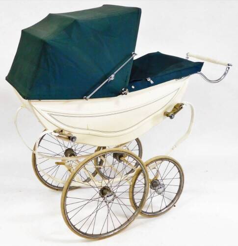 A vintage Osnath pram, metal framed in cream with green line decoration on a shaped base with four wheels, adjustable canopy and chrome mounts, 109cm wide.