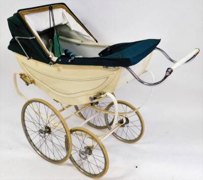 A vintage Osnath pram, metal framed in cream with green line decoration on a shaped base with four wheels, adjustable canopy and chrome mounts, 109cm wide. - 2