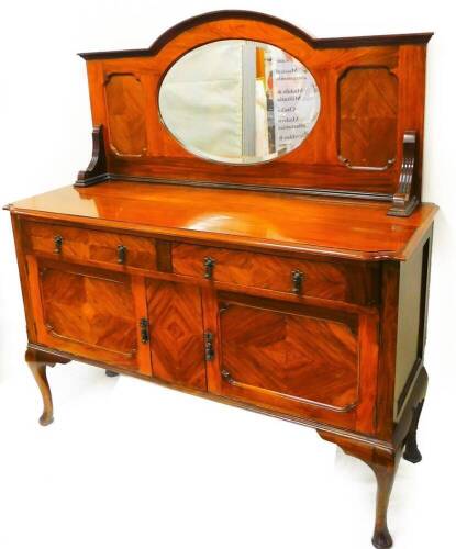 An Edwardian walnut mirror back sideboard, the oval bevel glass raised above two frieze drawers and double cupboard on cabriole legs terminating in pad feet, 143cm high, 36 wide, 60cm deep.