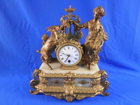 A late 19thC French gilt spelter and marble mantel timepiece with a white enamel dial