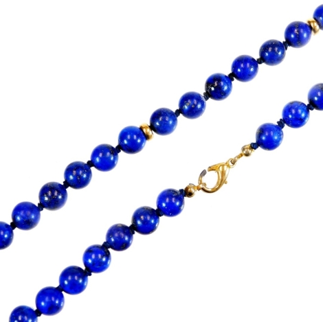 A lapis lazuli style necklace, with uniform beads broken in sections by banding with plain clasp, 38cm long.