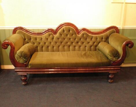 A Victorian mahogany show frame sofa with a shaped back