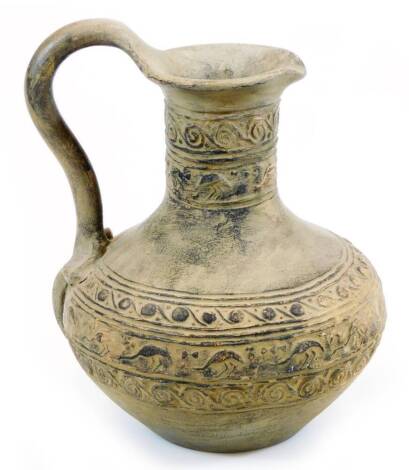 A hand thrown pottery ewer, in the Roman style, with an upper and lower geometric banding, plain double knop handle and circular foot, unmarked, 23cm high.