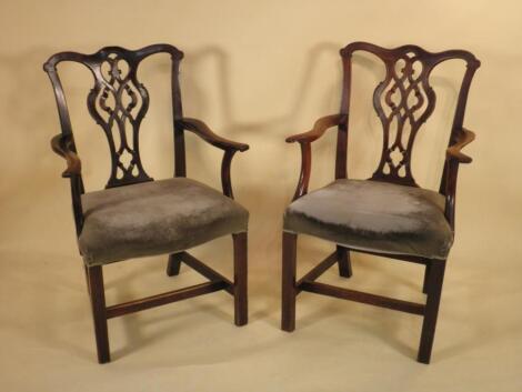 A pair of George III mahogany elbow chairs