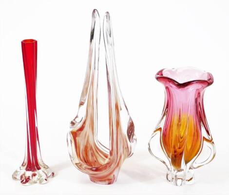 A Bohemian art glass vase, in pink, orange and clear forms, 23cm high, and two others. (3)