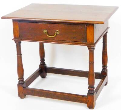 An 18thC style oak stained side table, of small proportion, the frieze drawer set with swan neck handles on baluster legs joined by plain block stretchers on block feet, 63cm high, 70cm wide, 46cm deep.