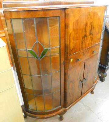 A mid 20thC walnut side by side bureau, the centre with fall, single drawer and double cupboard flanked by astragal glazed doors revealing glazed shelves on squat cabriole legs terminating in pad feet, 120cm high, 120cm wide, 37cm deep.