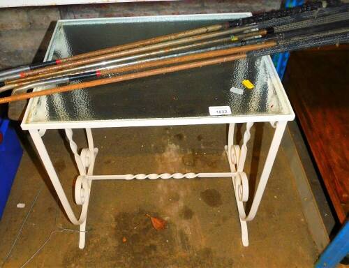 A glass topped and wire framed table, and a selection of various Petron and other golf clubs. (AF)